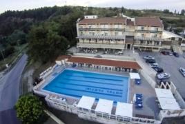 a large swimming pool in front of a building at Plotini Hotel in Dhidhimótikhon