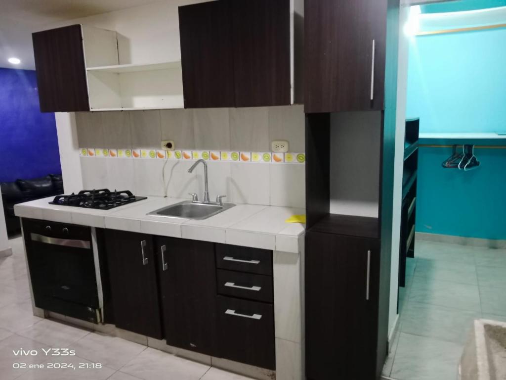 a kitchen with a sink and a stove at Hotel El Imperio in Santa Marta