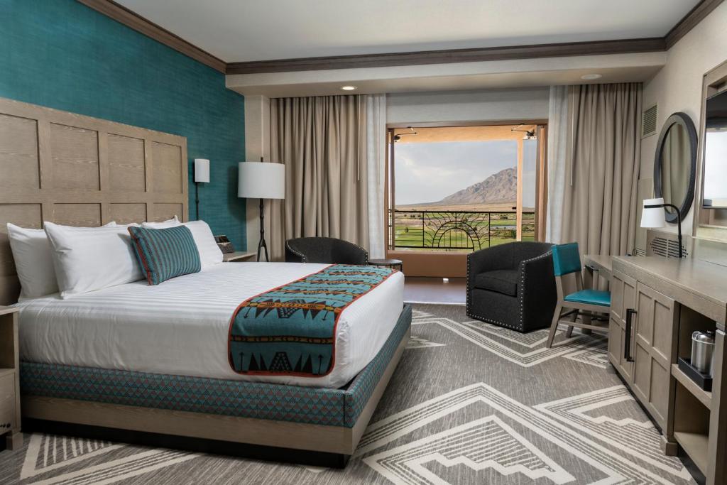 a hotel room with a bed and a balcony at Sandia Resort and Casino in Albuquerque