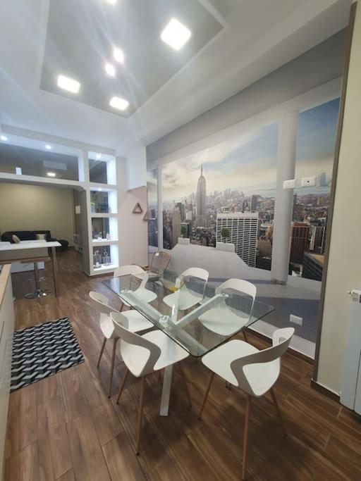 a living room with a table and chairs and a view of a city at My Dream House 386 in Angri