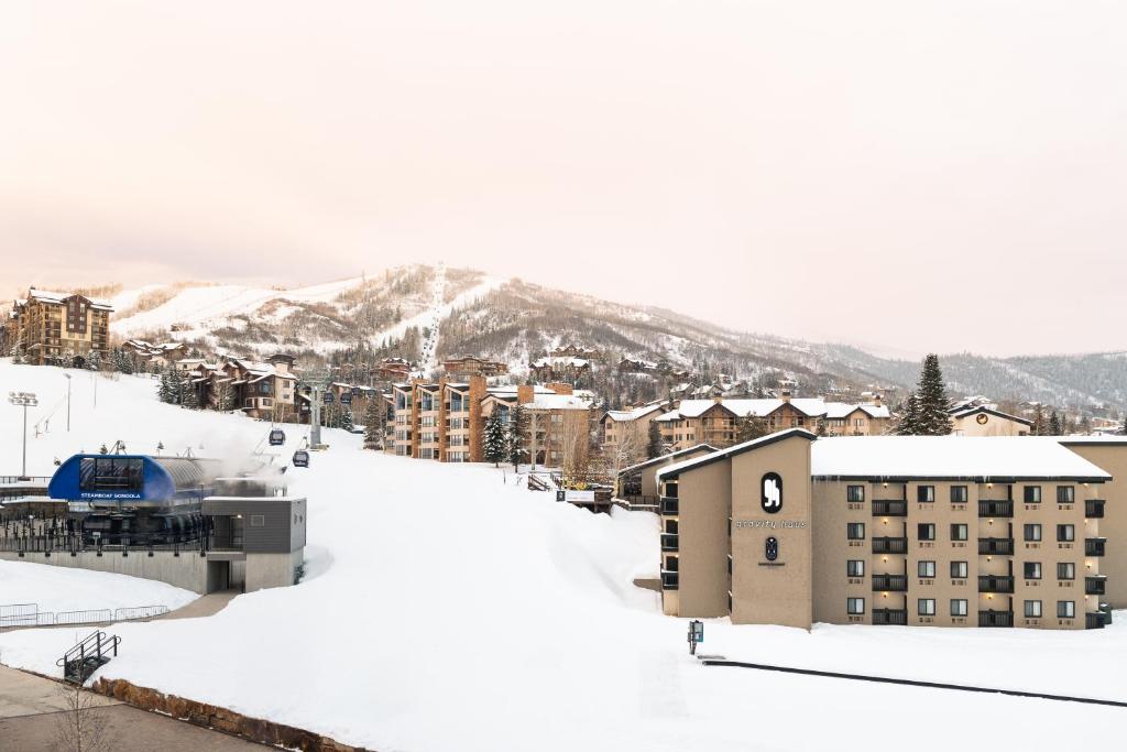 a snow covered city with buildings and a mountain at Gravity Haus Steamboat in Steamboat Springs