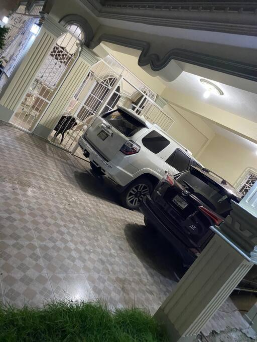 a truck parked in a garage next to a house at Casa completa in Azua de Compostela