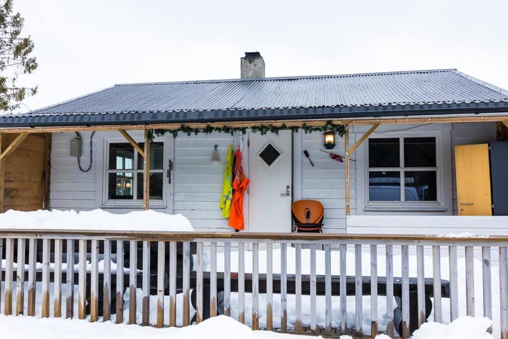ein kleines weißes Haus mit Schnee auf der Veranda in der Unterkunft Bontveit Villa s in Bergen