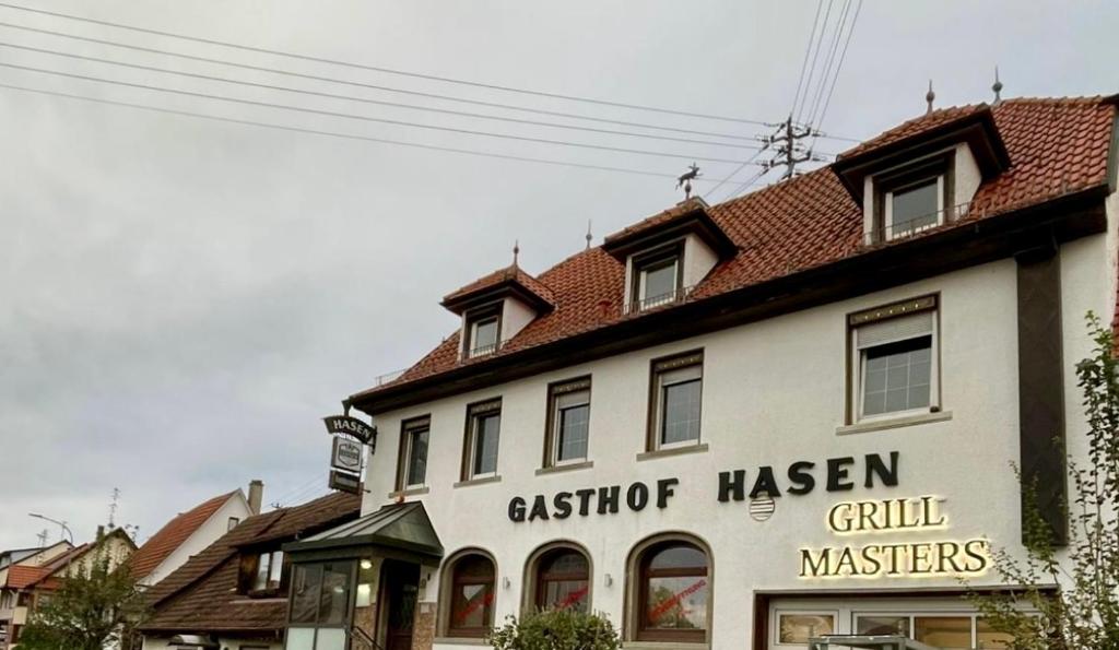 a building with a sign on the side of it at Gasthaus Hasen - Grill Masters in Geislingen