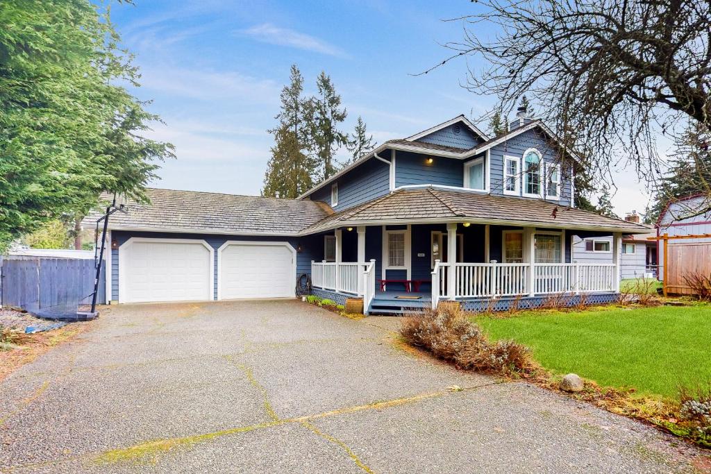 een blauw huis met een grote oprit ervoor bij Enchanting In Edmonds in Edmonds