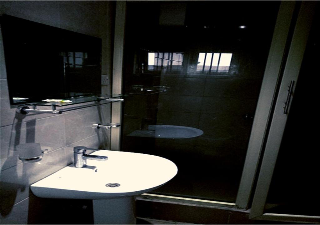 a bathroom with a sink and a shower at angelaMcFadden apartment in Benin City