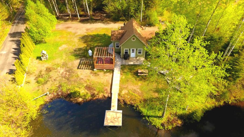 an aerial view of a house in the water at Chalets BSL in Saint-Simon-de-Rimouski