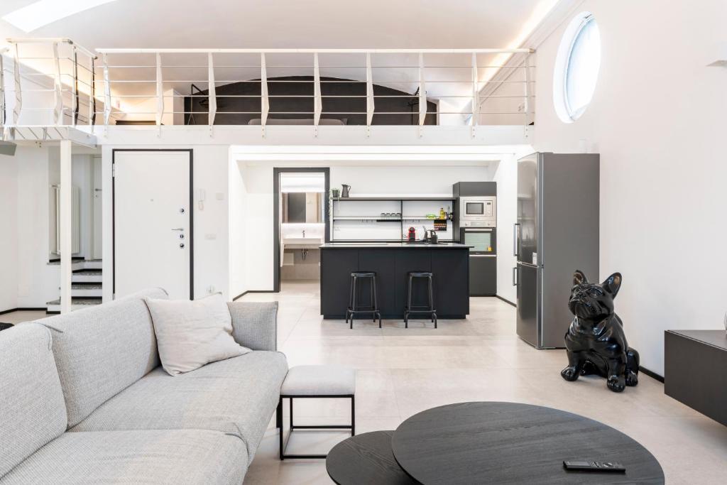 a living room with a couch and a kitchen at Diaz Novantuno - Luxury Apartments Como City Center in Como