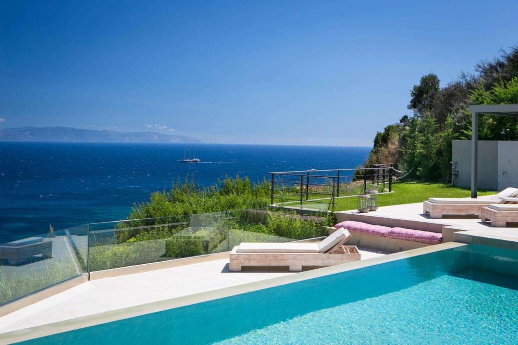 a swimming pool with a view of the ocean at Christina by Vintage Travel in Spartia