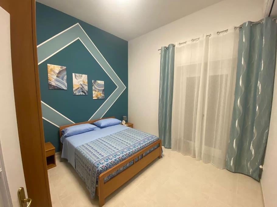 um quarto com uma cama e uma parede azul em Horizon em Castel San Giorgio