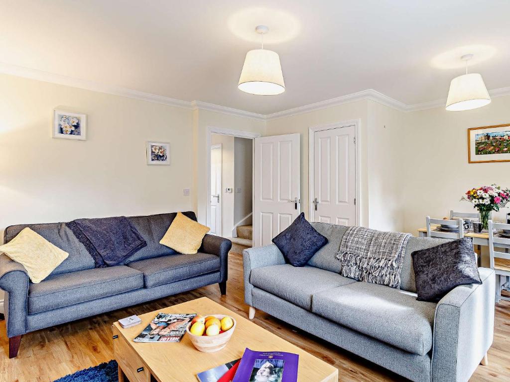 a living room with two couches and a table at 3 Bed in Overstrand 81481 in Overstrand
