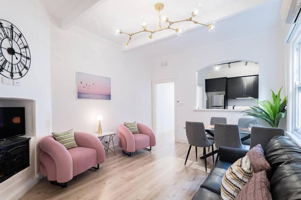 a living room with a couch and chairs and a table at Waterfront - KING Bed Master @ Rocks Sydney #9A in Sydney