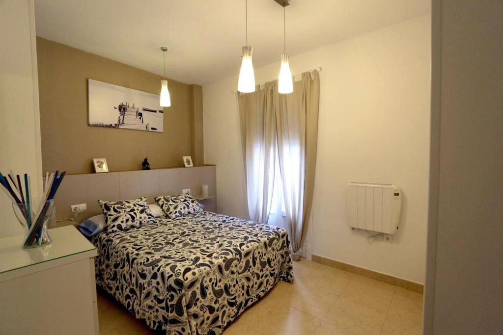 a bedroom with a bed with a black and white blanket at 2 bedrooms appartement with wifi at Arcos de la Frontera in Arcos de la Frontera