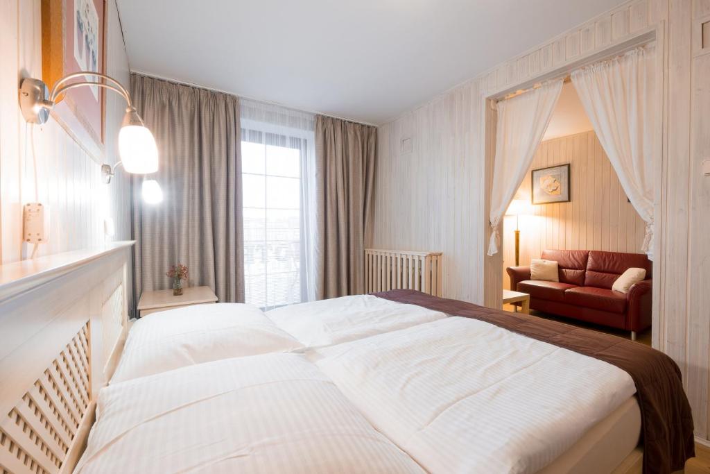 Postel nebo postele na pokoji v ubytování Hotel Maxant