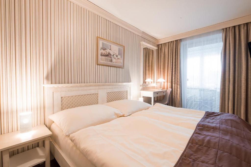 Postel nebo postele na pokoji v ubytování Hotel Maxant