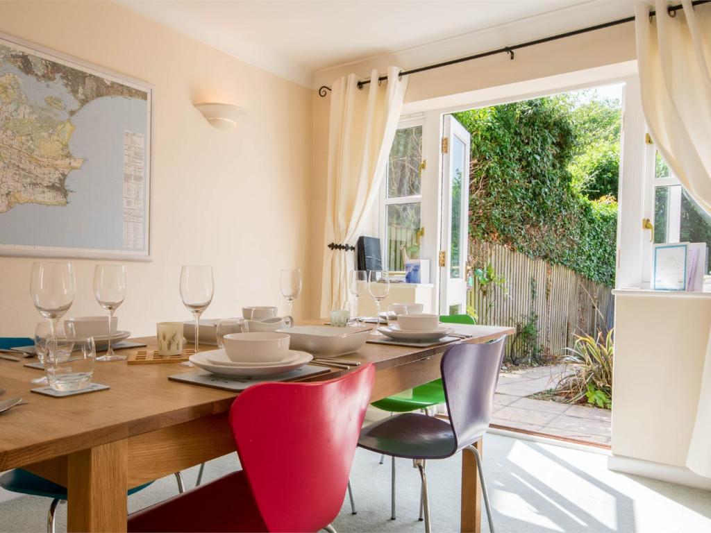 a dining room with a wooden table and chairs at 3 Bed in Studland DC072 in Studland
