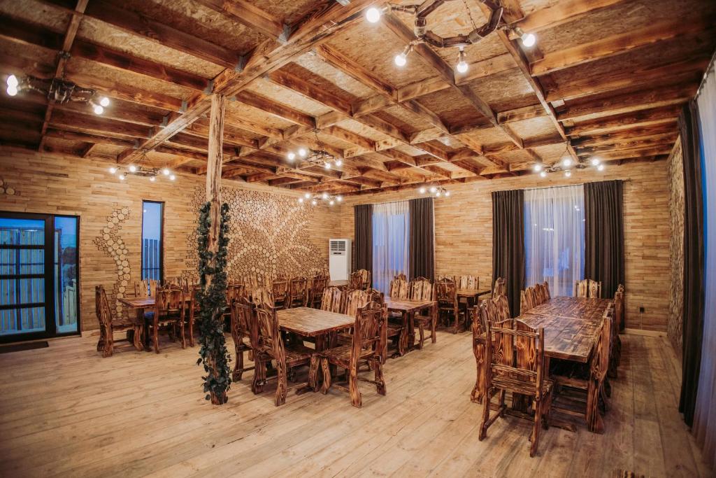 a dining room with wooden tables and chairs at The Mountain Villas in Hankʼavan