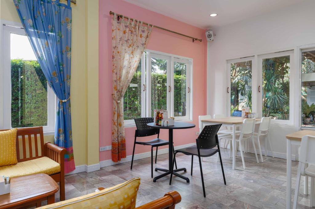A pastel lounge and dining area with garden-facing windows.