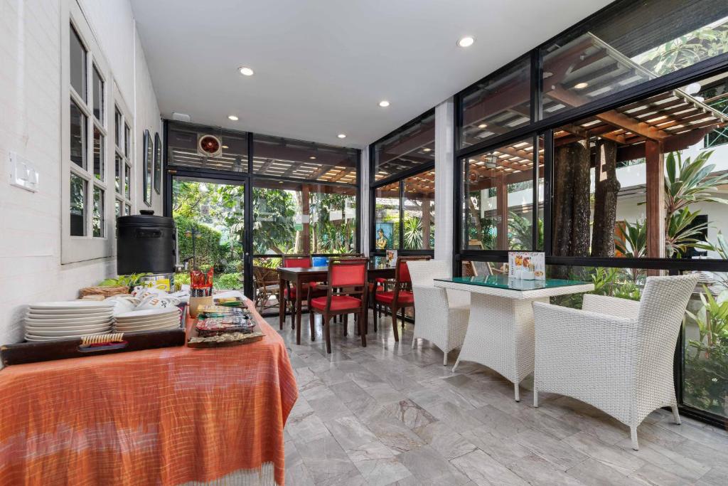 A bright, glass-walled dining room with buffet service and mixed seating.