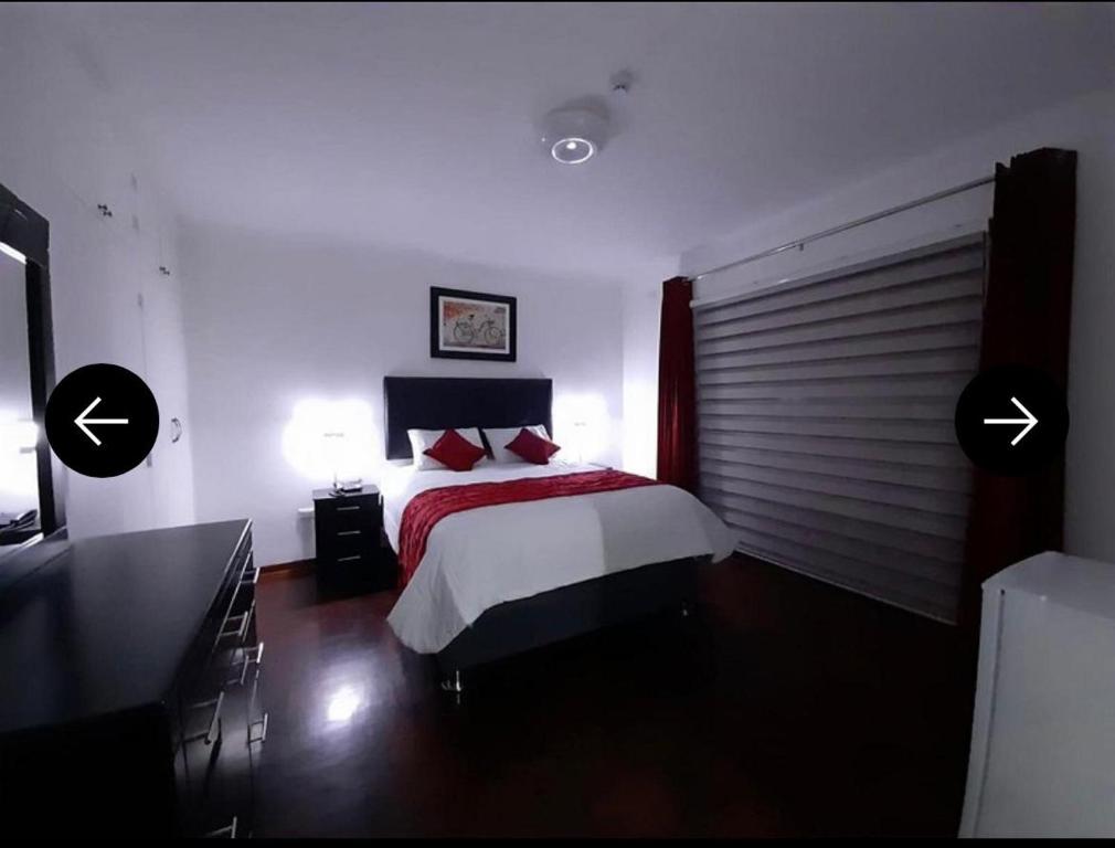 a bedroom with a bed and two lamps in it at Lima HOUSE MILANI in Lima