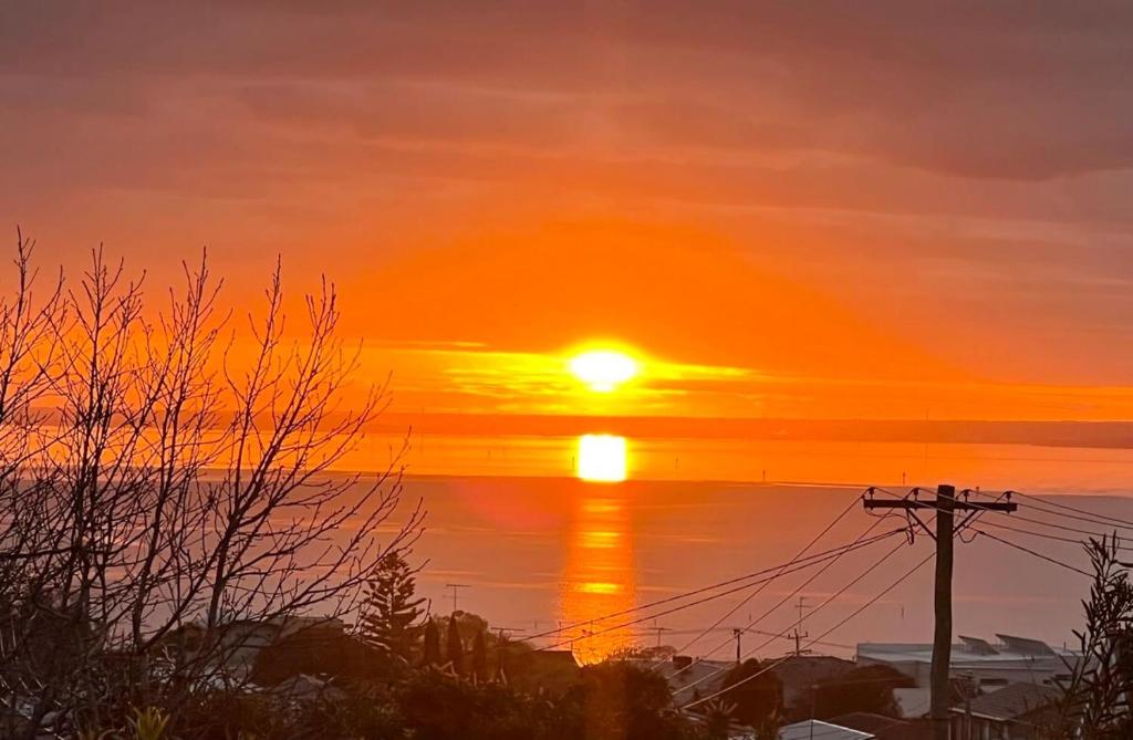 a sunset over a body of water at Seven Views I Pool Table n Water Views in Clifton Springs