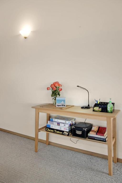 a table with a lamp and books on it at Seven Views I Pool Table n Water Views in Clifton Springs