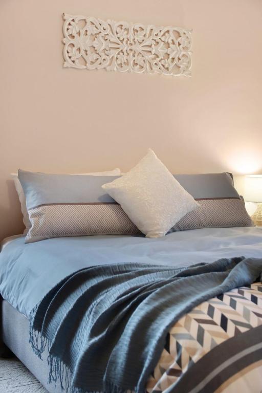 a bedroom with a bed with blue sheets and pillows at Seven Views I Pool Table n Water Views in Clifton Springs