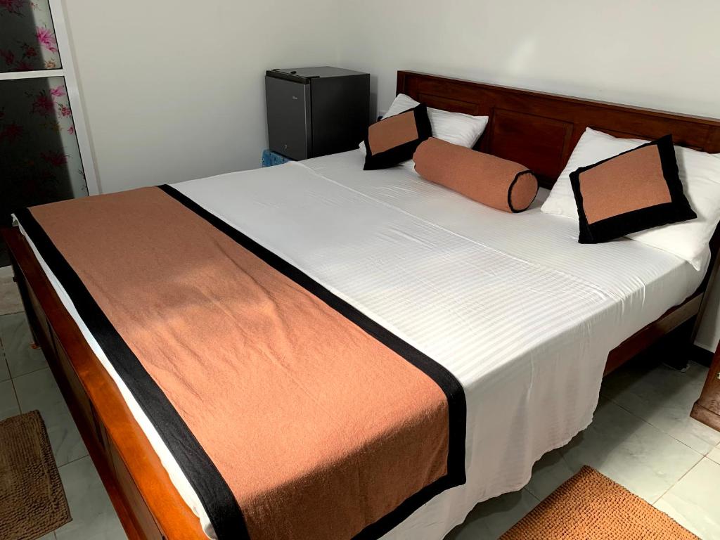 ein Bett mit zwei Kissen auf einem Zimmer in der Unterkunft TURTLE RESIDENCE & RESTAURANT in Talpe