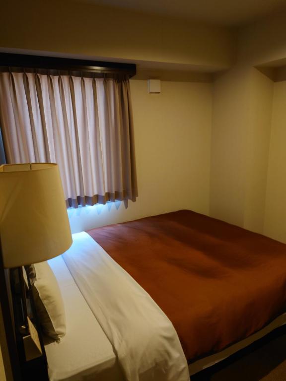 Postel nebo postele na pokoji v ubytování ホテルアイシス掛川