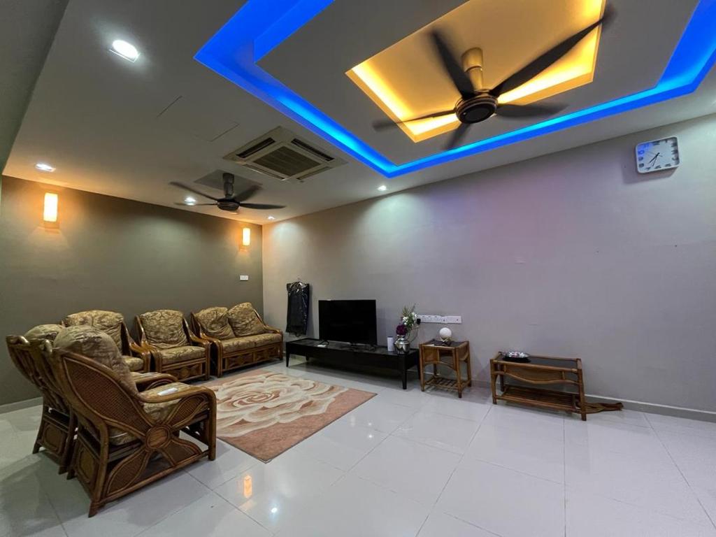 a living room with a ceiling with a blue light at Mega Homestay in Butterworth