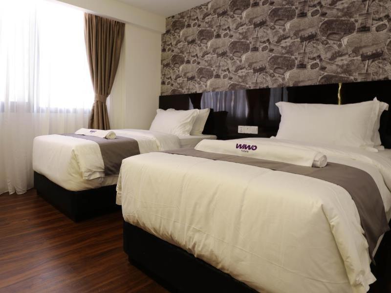 Postel nebo postele na pokoji v ubytování WIWO Hotel