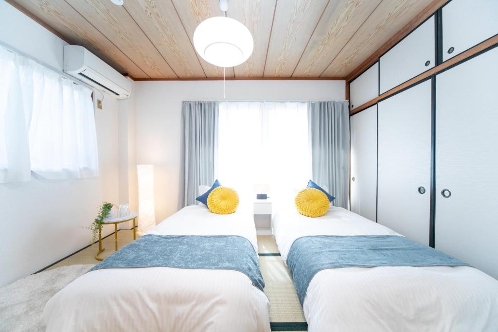 A bed or beds in a room at Suzuka Smile Room