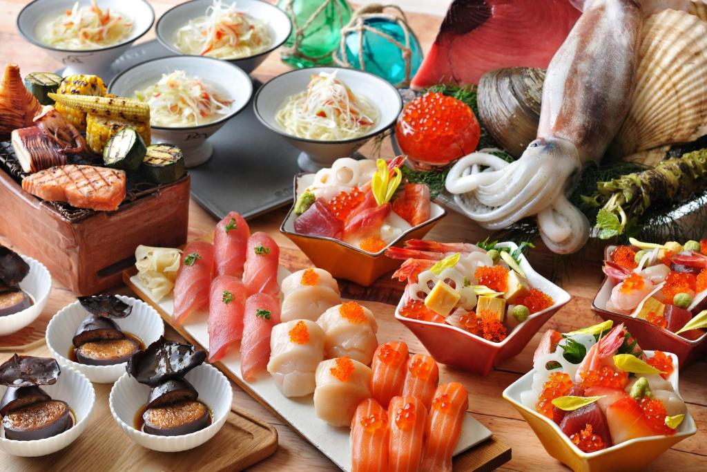 a table with many different types of food on it at OMO5 Hakodate by Hoshino Resorts in Hakodate