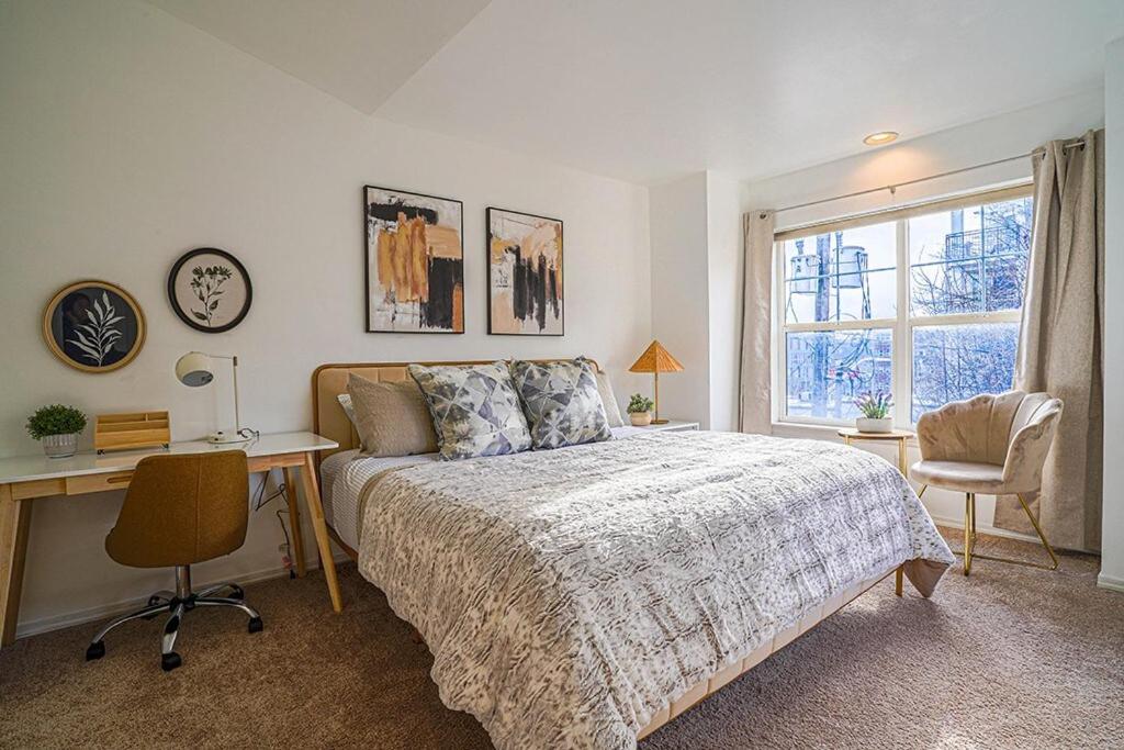 a bedroom with a bed and a desk and a window at Ballard's Townhome with office & walk score 98 in Seattle