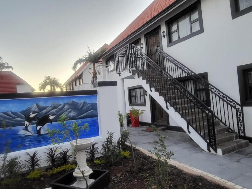 a house with a mural on the side of it at Orca Estate Guesthouse Self-catering Accommodation in Durban