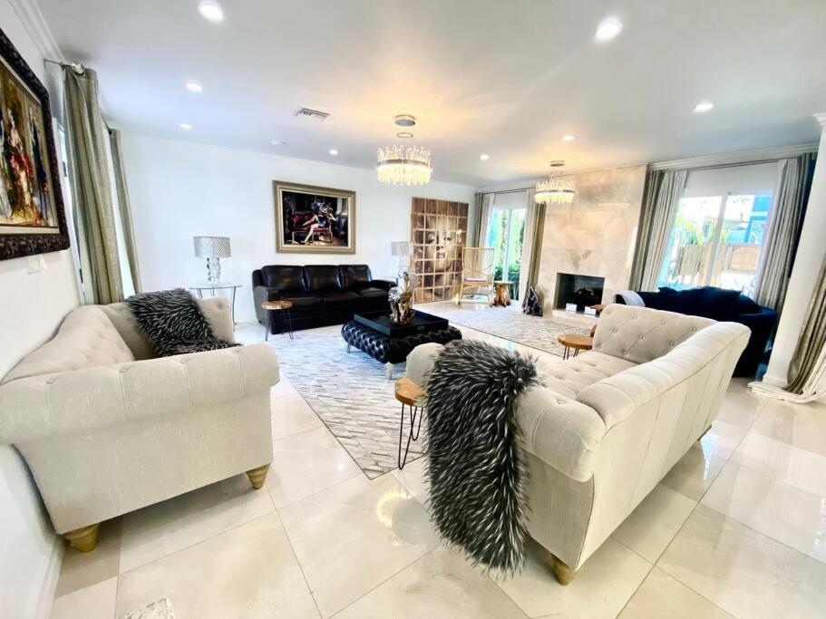 a living room with two couches and a living room with a couch at Luxury White Beach House in Redondo Beach