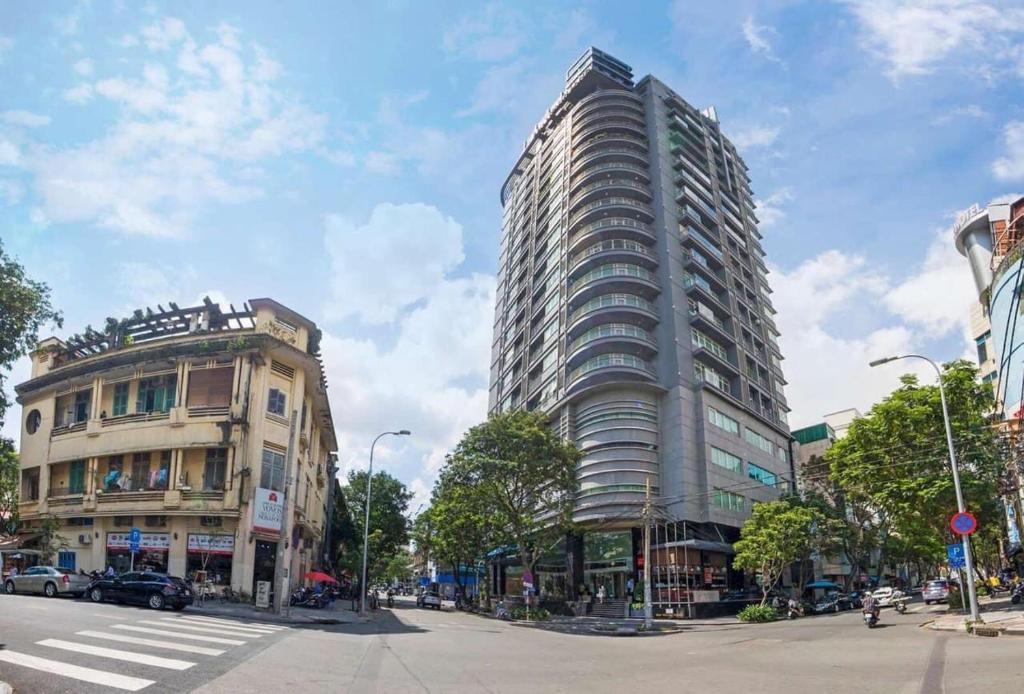 a tall building on a city street next to a building at Tracy Ben Thanh Tower in Ho Chi Minh City