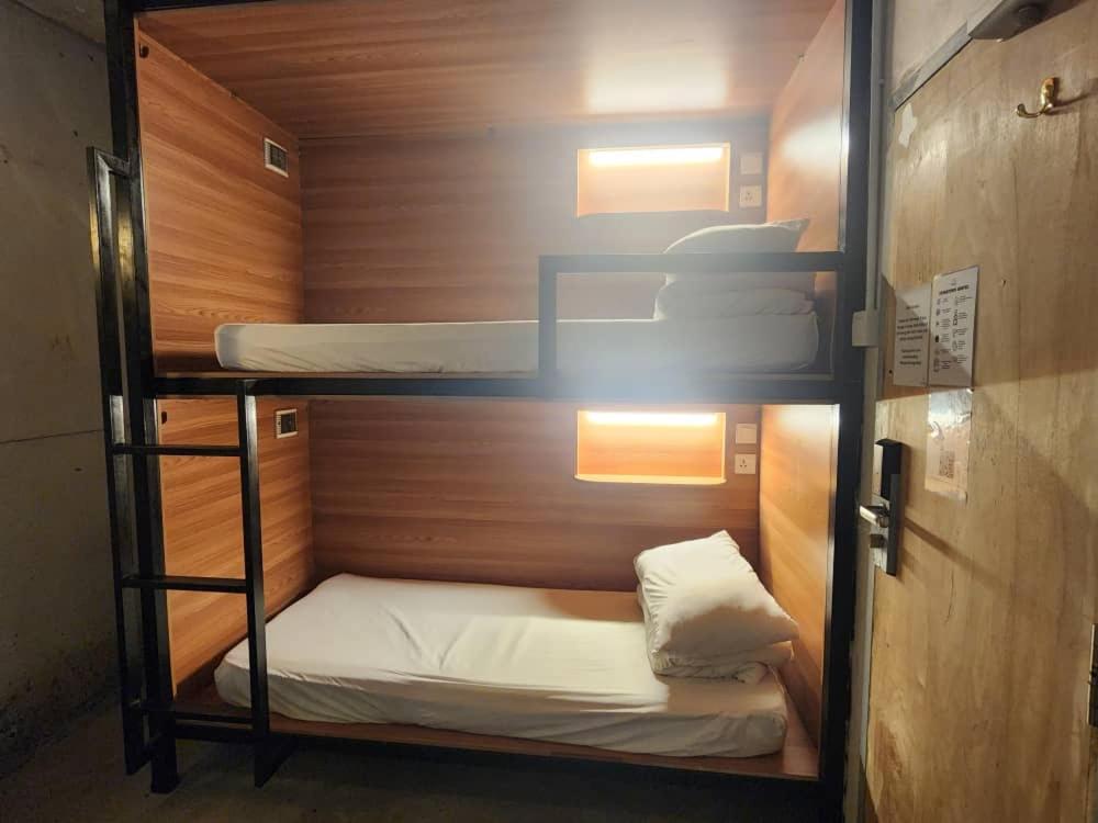 a small room with two bunk beds in it at Chinatown Hostel by Mingle in Kuala Lumpur