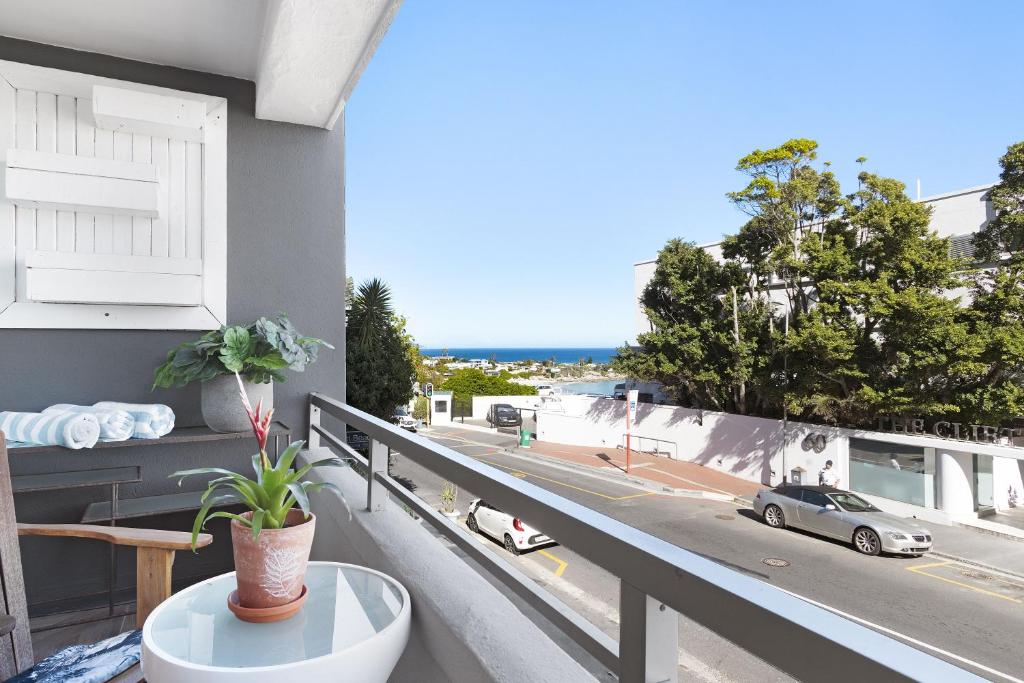 a balcony with a table and a view of a street at Clifton Studio 104 in Cape Town