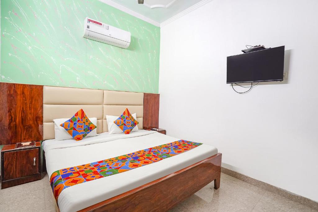 a bedroom with a bed and a television in it at FabHotel Taj Stay in Agra