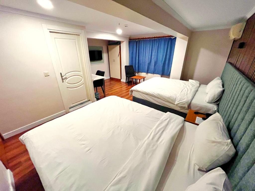Postel nebo postele na pokoji v ubytování Naila Hotel