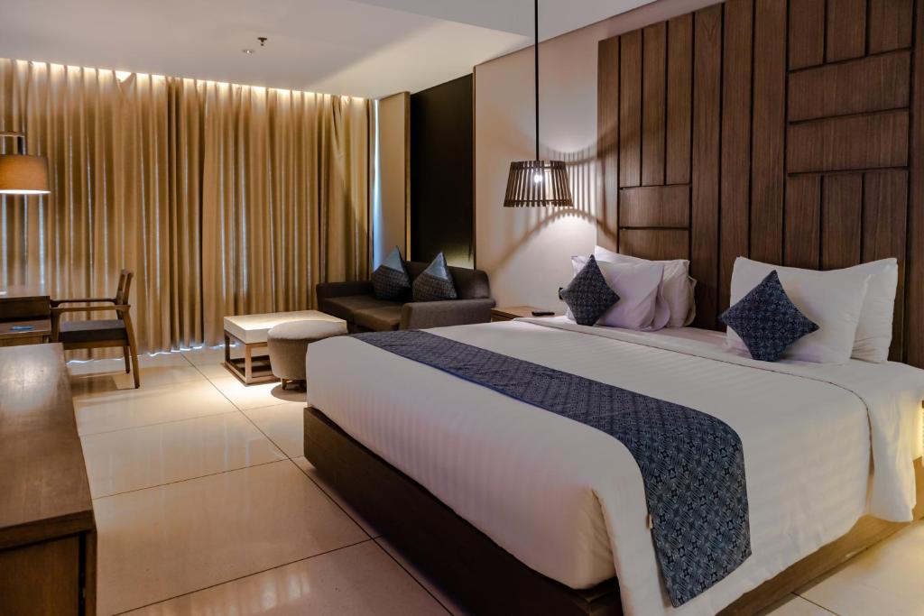 Postel nebo postele na pokoji v ubytování Wyndham Tamansari Jivva Resort Bali