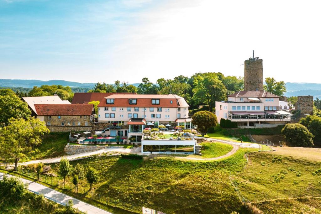 an aerial view of a building with a castle at Burghotel Staufeneck in Salach