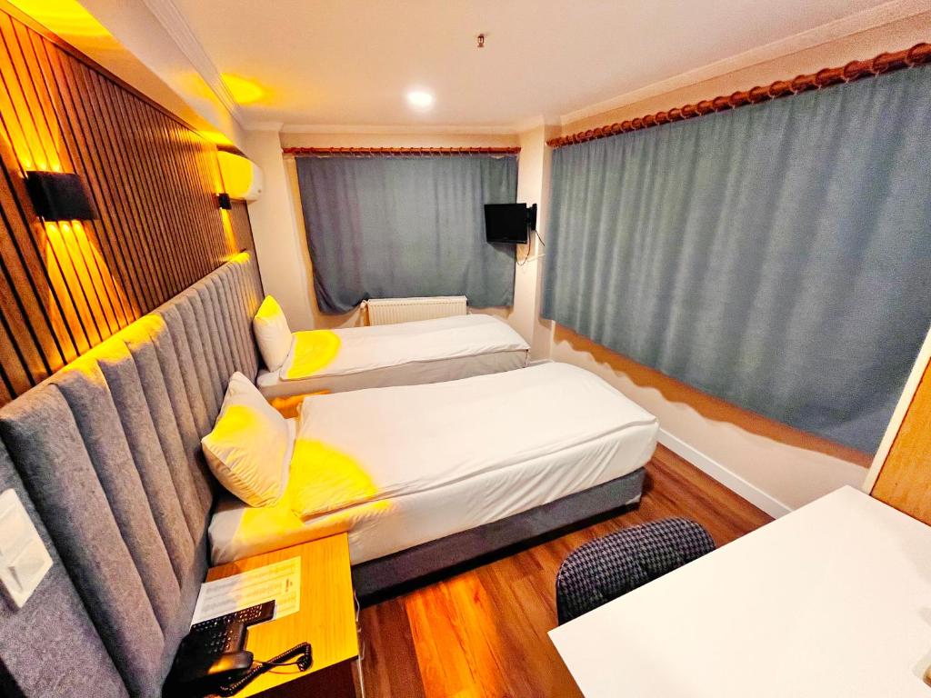 Postel nebo postele na pokoji v ubytování Naila Hotel