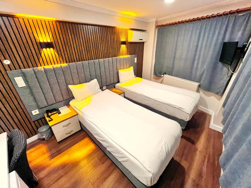 Postel nebo postele na pokoji v ubytování Naila Hotel