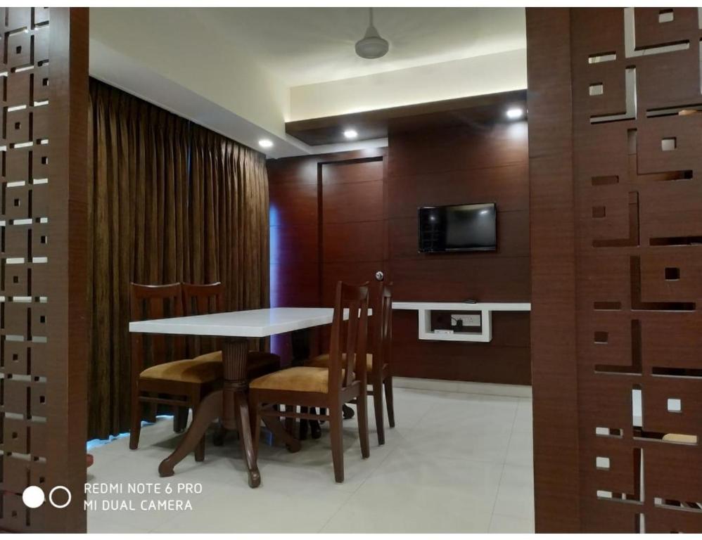 a dining room with a table and chairs at Hotel Maurya International, Chennai in Chennai