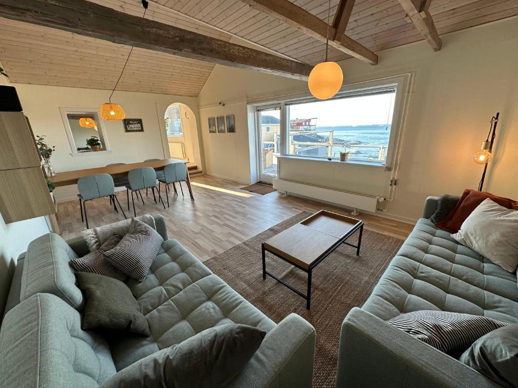 a living room with a couch and a table at Grand seaview house Ilulissat in Ilulissat