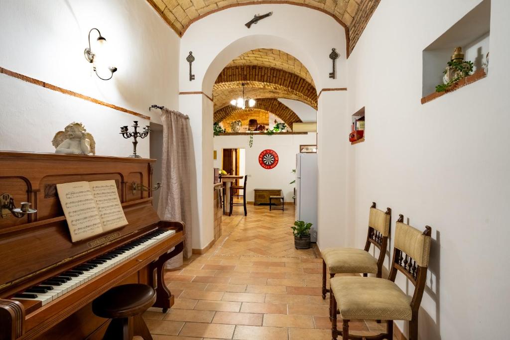 a hallway with a piano and a dining room at DOMUS GELSOMINO in Rome