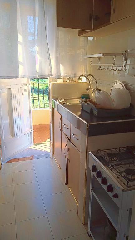 a kitchen with a sink and a stove top oven at Serene Safaris Airbnb in Thika in Thika