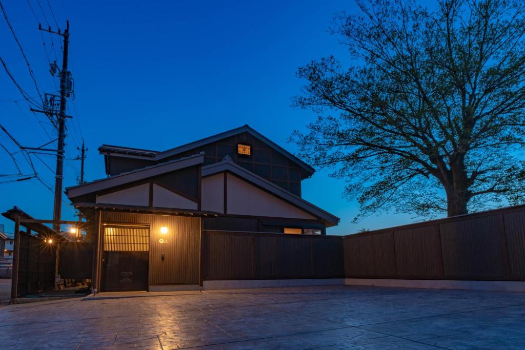 a house with a garage at night at 十八楼離れ 宿いとう in Gifu